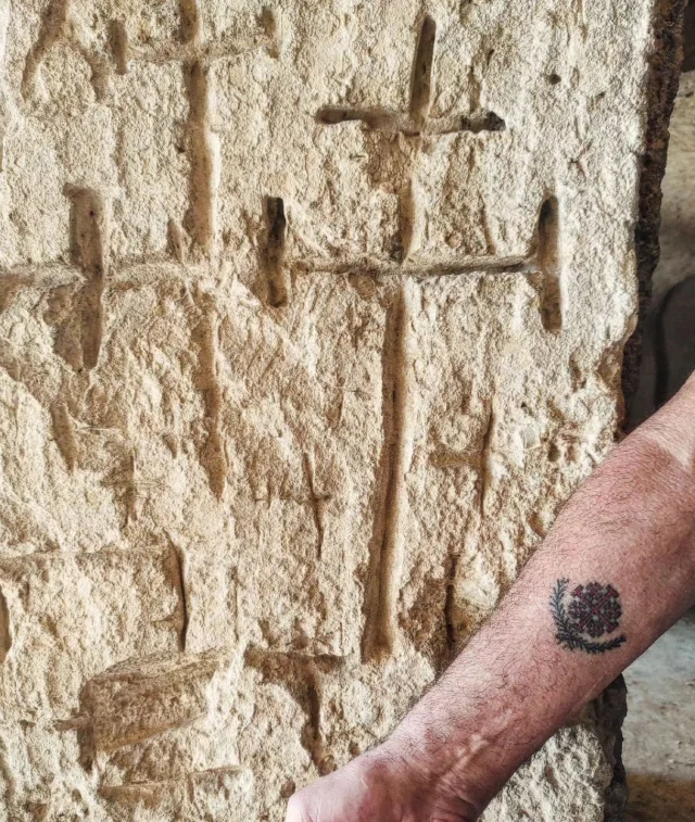 Centuries ago, someone (perhaps a pilgrim traveling to or from the Holy Land?) carved this Jerusalem Cross into the rocky pillar of this rock-hewn church in Matera. Today, a visitor bears the same symbol, tattooed on his forearm by Wassim Razzouk, the 27th generation of a family that has been passing down this tradition in Jerusalem since the 1300s.